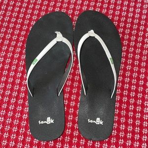Black Sanuk flip flops